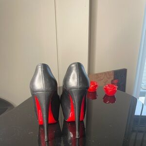 Christian Louboutin heels Size 37 1/2 minor scuffs on leather and red bottom